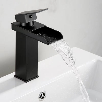 Black waterfall bathroom faucet with water flowing into a basin